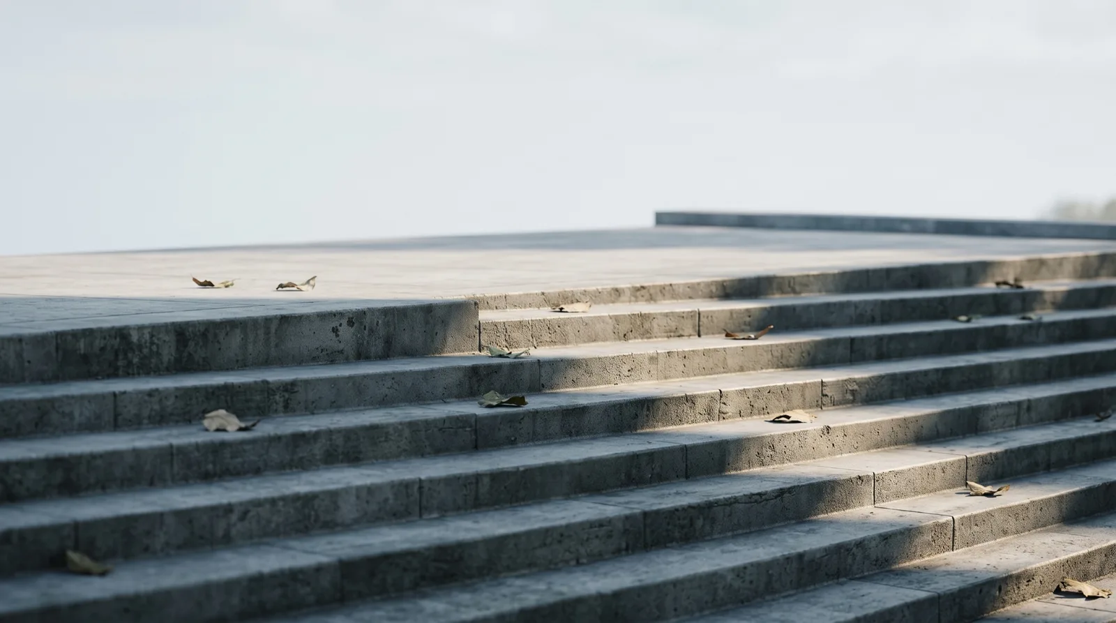 Wide concrete staircase leading to one landing, illustrating E8 One's single-phase challenge