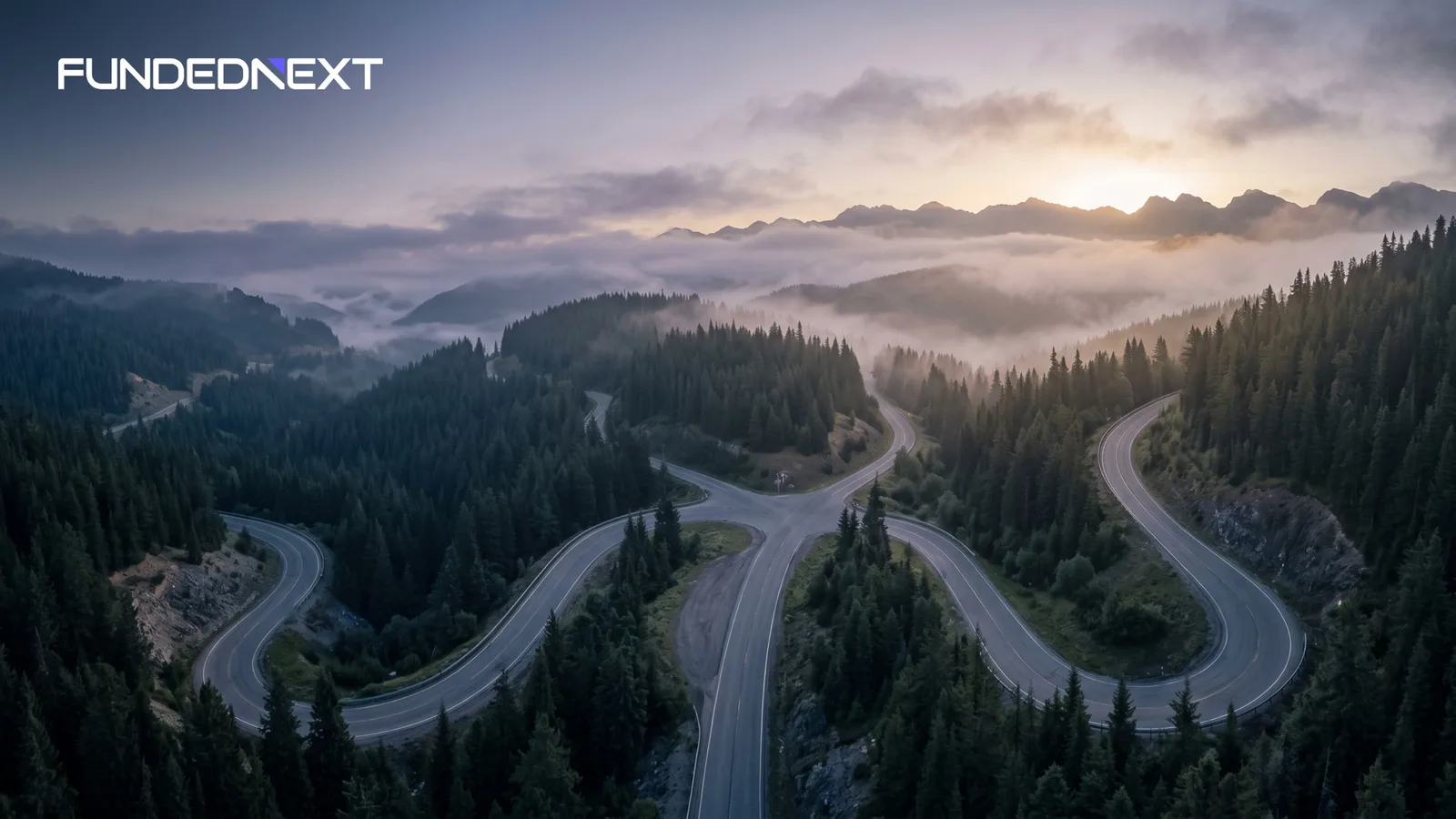 Aerial view of a mountain road splitting into four routes, a picture of choosing between FundedNext account types
