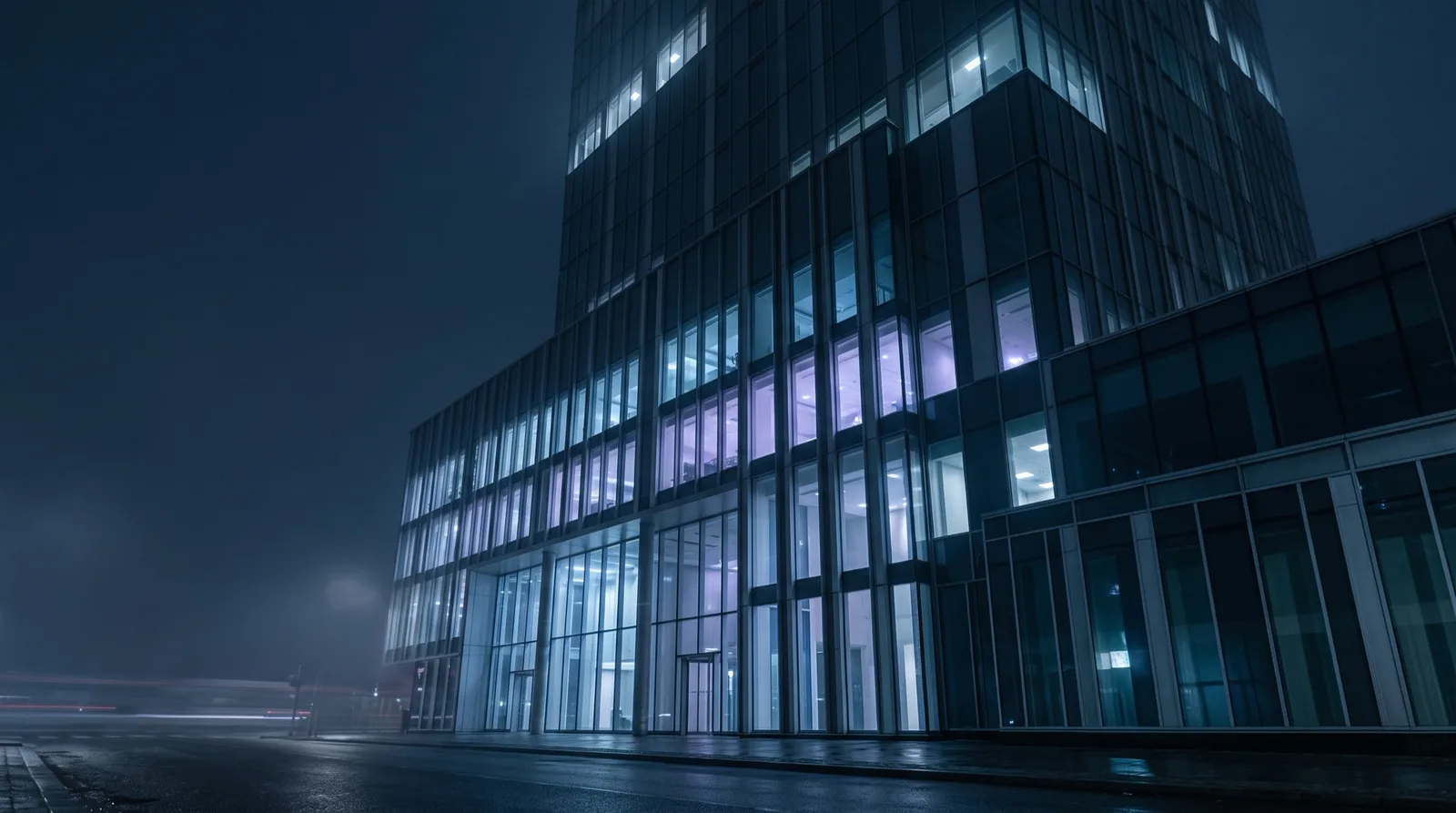 Modern glass building lit blue at night, cover image for the Hypernova prop firm guide